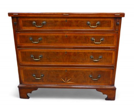 A George III and later walnut bachelors chest, with a star inlaid folder top above three long graduating drawers on bracket f