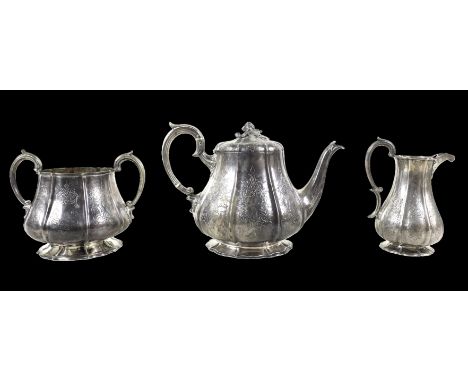 A Victorian three piece tea set, of bombe shape with engraved decoration, the teapot with acorn finial and ivory insulators, 