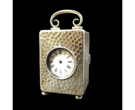 An Edward VII silver travel clock with a French movement, London 1904, 5.5 by 5 by 10cm with handle up.Not currently working.