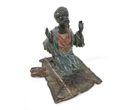 A Franz Bergman cold painted bronze figural group, early 20th century, modelled as a man on his knees praying, with a bamboo 