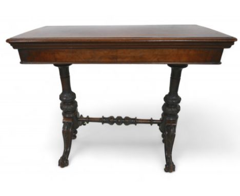 A Victorian burr walnut fold over top card table, on turned and carved pillar supports united by a turned stretcher, 92 by 45