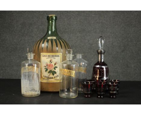 A collection of glass including a large rose water green glass demijohn, a Venetian silvered ruby glass decanter and glasses 