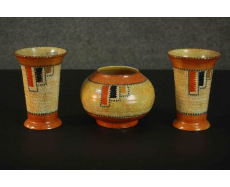 Charlotte Rhead for Crown Ducal, three 1930s Art Deco pottery items, each in the Stitch pattern, comprising a pair of vases a