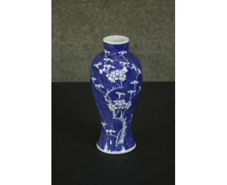 A Chinese 19th century blue and white prunus design porcelain vase, Kangxi mark to base. H.27 Dia.11cm. 