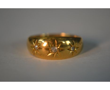 An 18ct yellow gold and old mine diamond gypsy ring, set with three cushion shaped old mine diamonds set in star cut settings