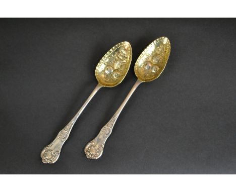 A pair of Victorian James and William Marshall Scottish silver berry spoons with gilded bowls and repousse fruit design. Hall