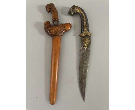 A SMALL MALAYSIAN DAGGER (KRIS), 20TH CENTURY in its scabbard, carved with a monster on the wranka; together with an Indian d