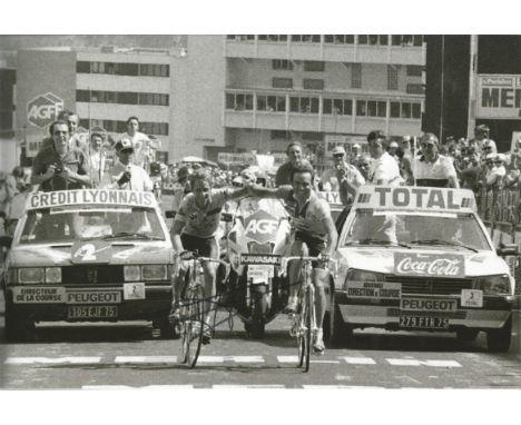 Autographed BERBARD HINAULT photo, a superb image depicting Hinault and Greg LeMond arm in arm as they cross the finish line 