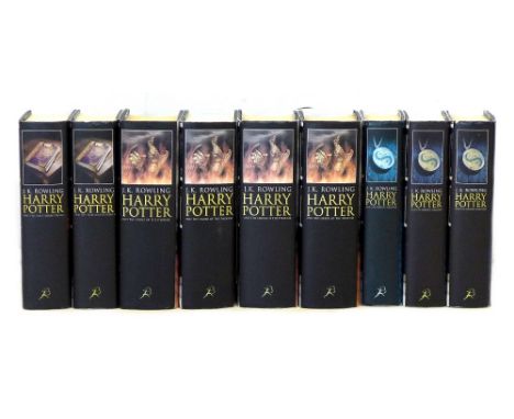 A collection of nine Harry Potter books with first complete adult collection cover art (black), all hardcovers with dust jack