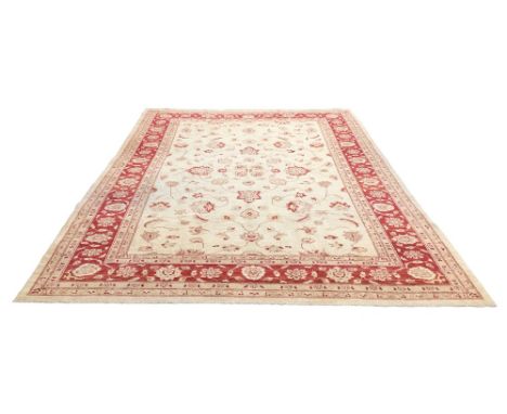 Two late 20th century rugs, comprising a modern Persian carpet, in Isfahan style, with cream ground and red floral and foliat