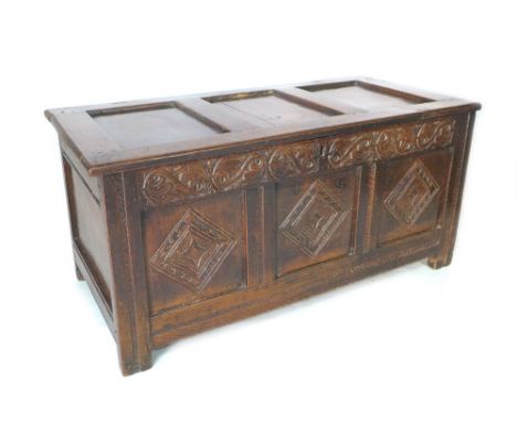 A late 17th/early 18th oak coffer, with lift top over a three panel front carved with diamond lozenges, initials I. C carved 