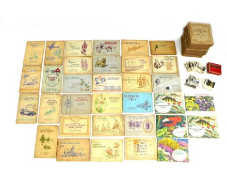 A large collection of cigarette and tea cards in albums, including those by John Player & Sons, W. D. & H. O. Wills, Ringer's