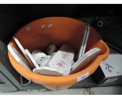 A bucket of ceramic door furniture