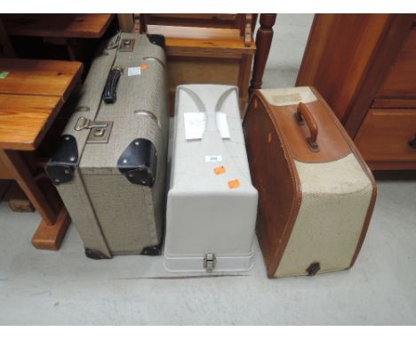 Two vintage sewing machines and a travel case