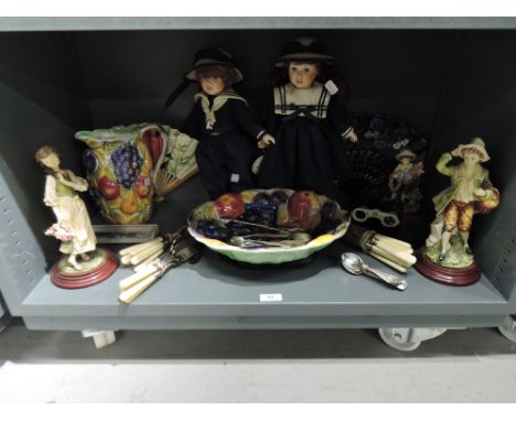 A shelf of micellaneous including opera glasses, collectors dolls, fan, flatware etc