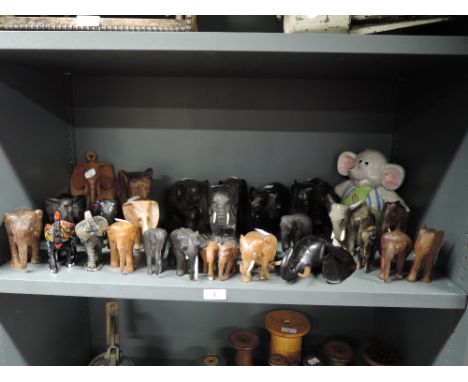 A herd of hand carved African and similar elephants including Ethnic woods and ceramic
