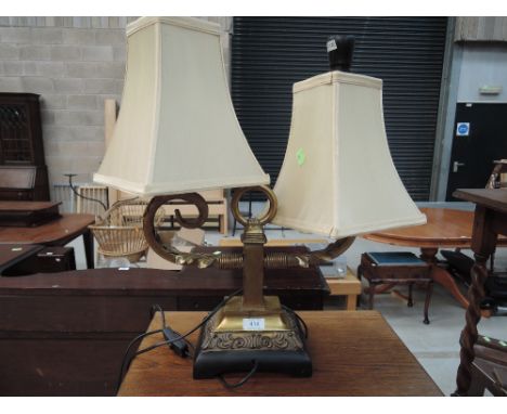 A reproduction classical style two branch table lamp
