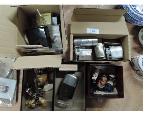 A selection of vintage lighters, badges and wood figures 