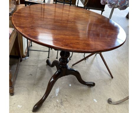 A 19th century mahogany tripod table with a circular top on a bird cage action baluster column and three legs