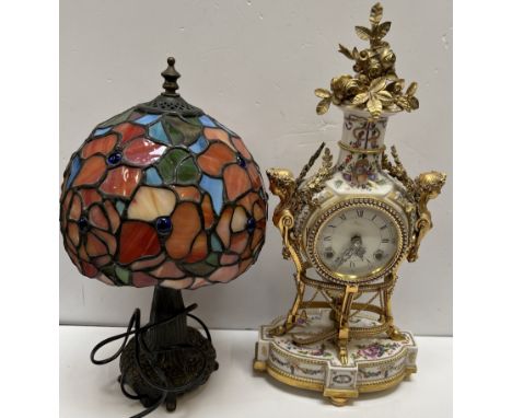 A continental porcelain and gilt metal mounted mantle clock together with a Tiffany style table lamp