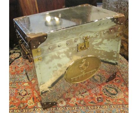 TRUNK, polished metal with a rising top enlosing storage space and an oval plaque inscribed 'Ferrari' to the front, 62cm W x 