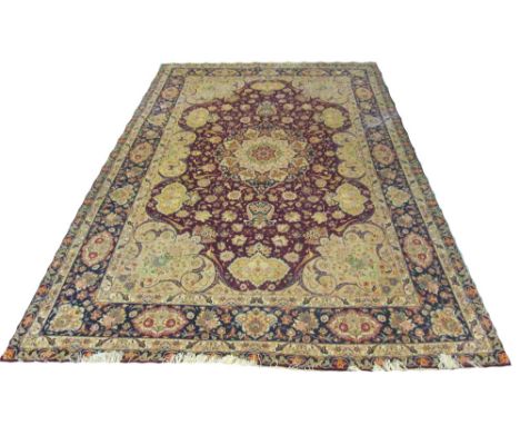 FINE PART SILK TABRIZ DESIGN CARPET, 305cm x 197cm, central medallion on a ruby field of palmettes, flowerheads and scrolling