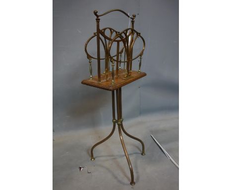 An Art Nouveau brass and oak revolving magazine rack, H.80cm 