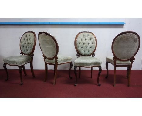 A set of four Victorian rosewood dining chairs, with button back velour upholstery 