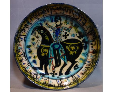 A Persian glazed ceramic bowl, decorated with a figure on horseback, date and mark to base, H.7cm Diameter 25cm 