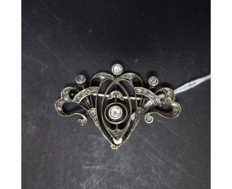 An Art Nouveau white metal and diamond set brooch, H.3.5 W.5cm 