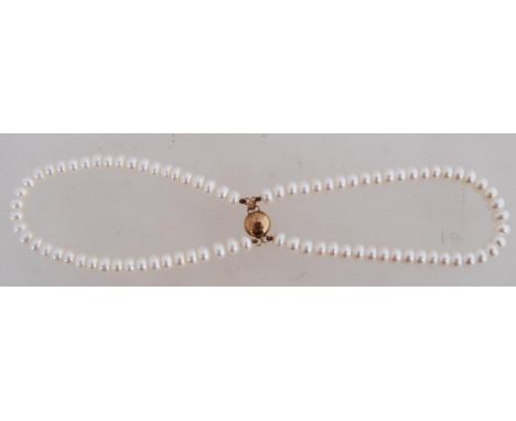 A good button pearl twin string bracelet strung with knotted button pearls with yellow metal clasp.