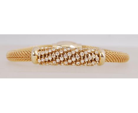 A good yellow metal woven chain bracelet with rhinestone set spiral decoration with magnetic clasp. Measures 8 inches.