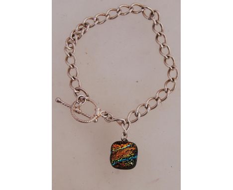 A 925 silver chain bracelet with glass pendant and toggle clasp. Measures 7.5inches. Marked 925.
