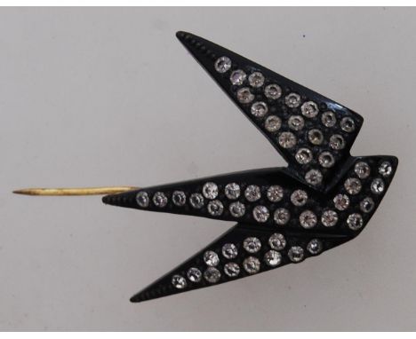 A 1930's Art Deco black bakelite figural hat pin in the form of a swallow bird set with paste stones with gold tone pin. Meas