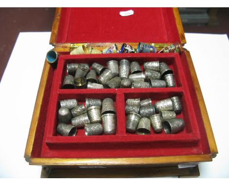 A Collection of Assorted Thimbles, including hallmarked silver, vintage enamel, modern cloisonné, etc, contained in a wooden 