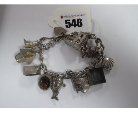 A Curb Link Charm Bracelet, to hallmarked silver heart shape padlock clasp, suspending assorted novelty charm pendants.