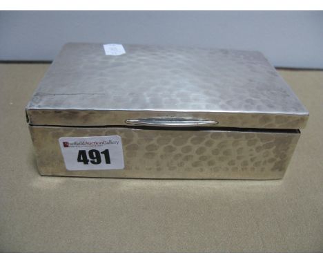 A Silver Cigarette Box, with planished finish, Birmingham hallmark 13.5cm wide.