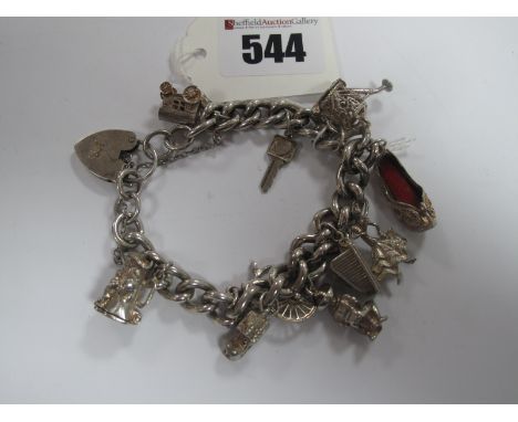 A Curb Link Charm Bracelet, to hallmarked silver heart shape padlock clasp, suspending assorted novelty charm pendants.