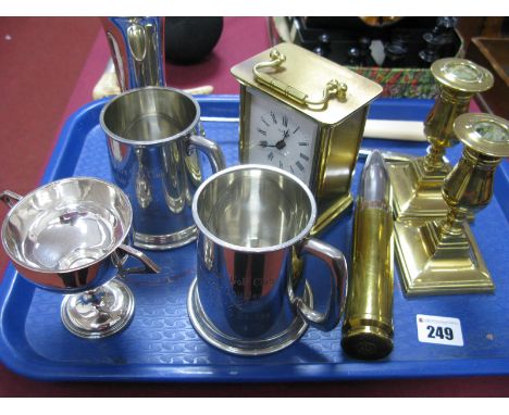 Estyma Carriage Clock, brass shell case, squat candlesticks, golfing trophy and tankards, pen etc:- One Tray