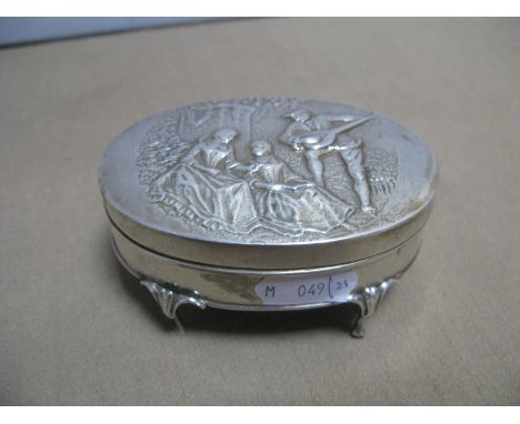 An Oval Silver Trinket Box, the lid embossed with musician and ladies in garden scene, on four cabriole legs, 9.5cm wide.