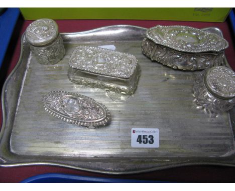 A Hallmarked Silver Trinket Box, of shaped oval design allover detailed in relief, initialled (holes); together with four hal