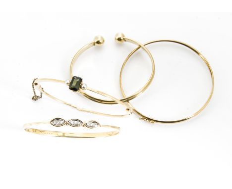 A 14ct gold diamond set bangle, 9.4g, together with a green tourmaline and seed pearl bangle, 11g, and two 9ct gold bangles 6