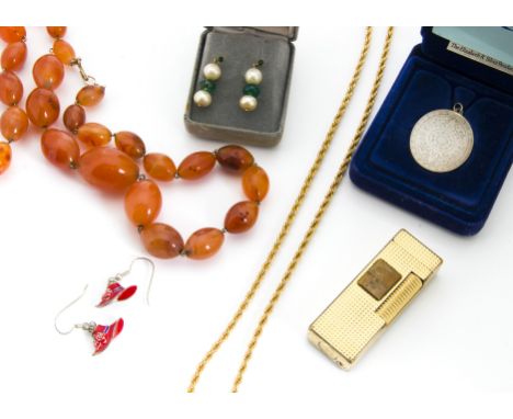 A small quantity of costume jewellery, including a 15ct gold garnet set stick pin, a silver dress ring, various items of gilt