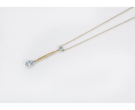 An Edwardian 15ct gold and aquamarine necklace, the chain supporting a round cut light blue stone with bar and further pear s