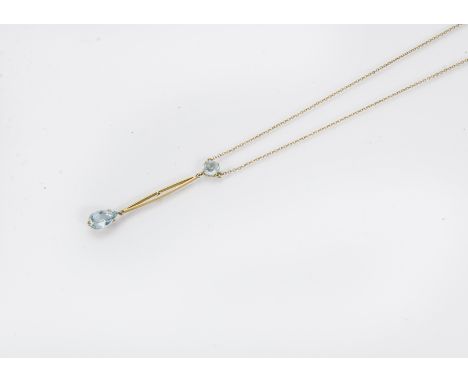 An Edwardian 15ct gold and aquamarine necklace, the chain supporting a round cut light blue stone with bar and further pear s