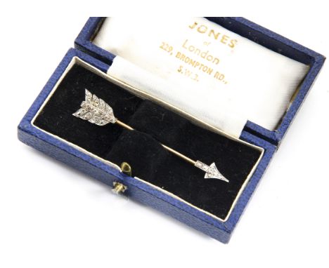 An early 20th Century gold and platinum diamond set stick pin, the old cut stones in millegrain setting to arrow head and fea