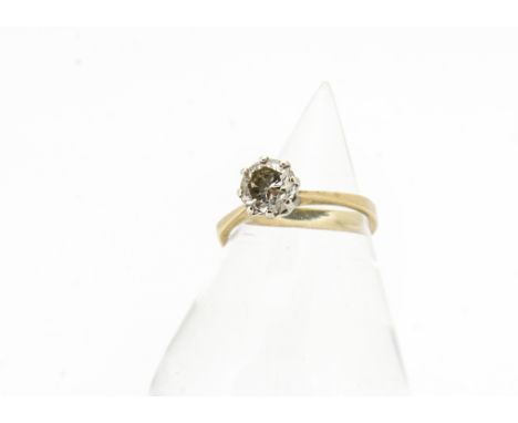 An 18ct gold diamond solitaire ring, brilliant cut circular diamond in eight claw white gold setting on a yellow metal shank,