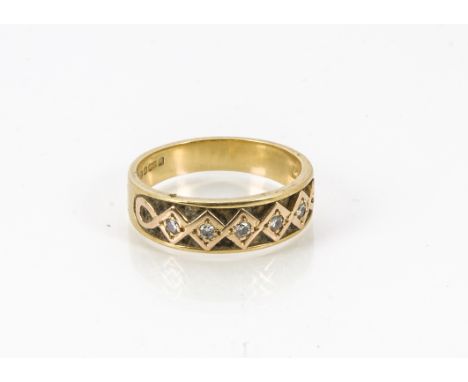 A modern 18ct gold and diamond ring, the tapered band with five brilliant cuts in zig zag setting, hallmarked, also with drag