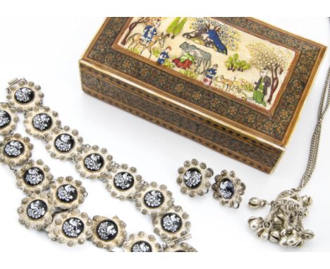 A white metal and enamel suite of Persian jewels, comprising necklace, bracelet and pair of earrings each with shaped petal d