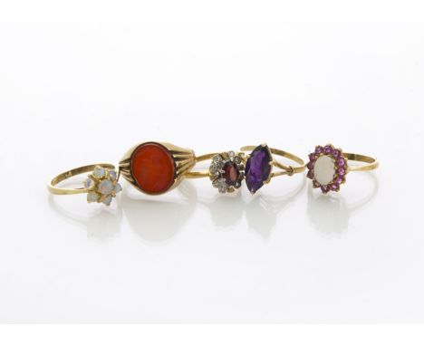 A collection of five gold rings, including two white opal cluster rings, a garnet and diamond dress ring, an amethyst dress r